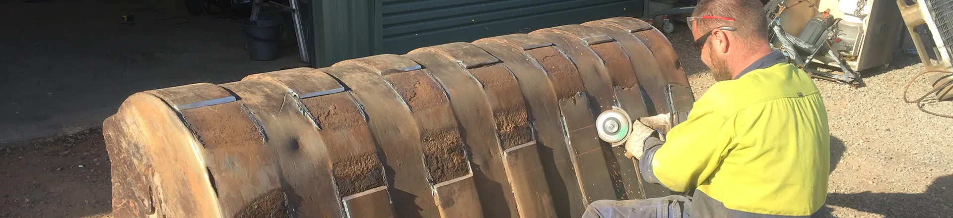 A worker cutting iron